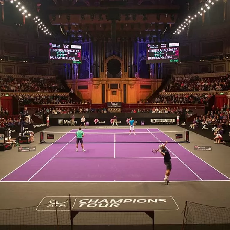 A player serves on the Champions Tour at the Royal Albert Hall