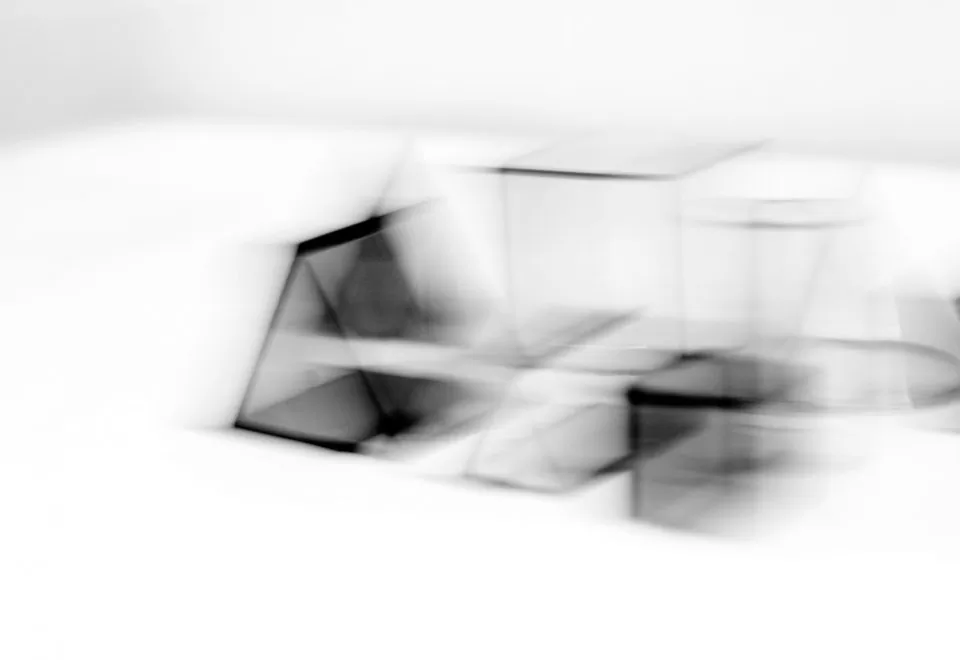 Blurred black and white composition of minimal shapes.