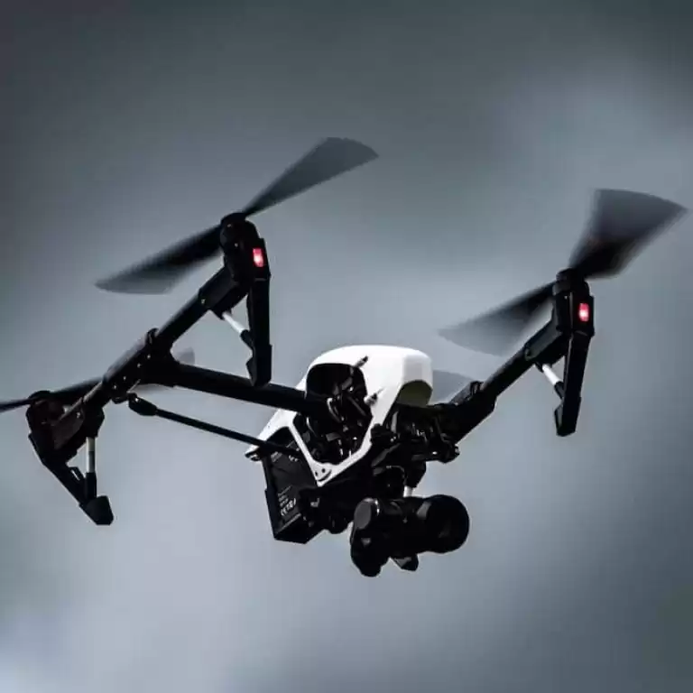 A drone in flight in cloudy skies.