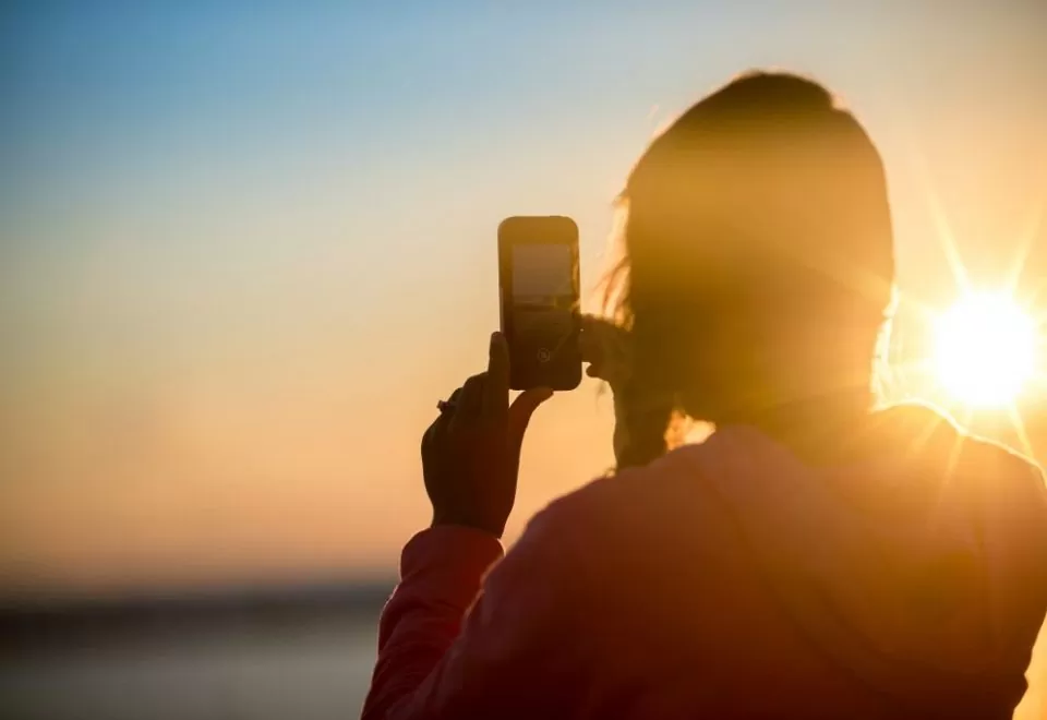 woman taking photo with smartphone