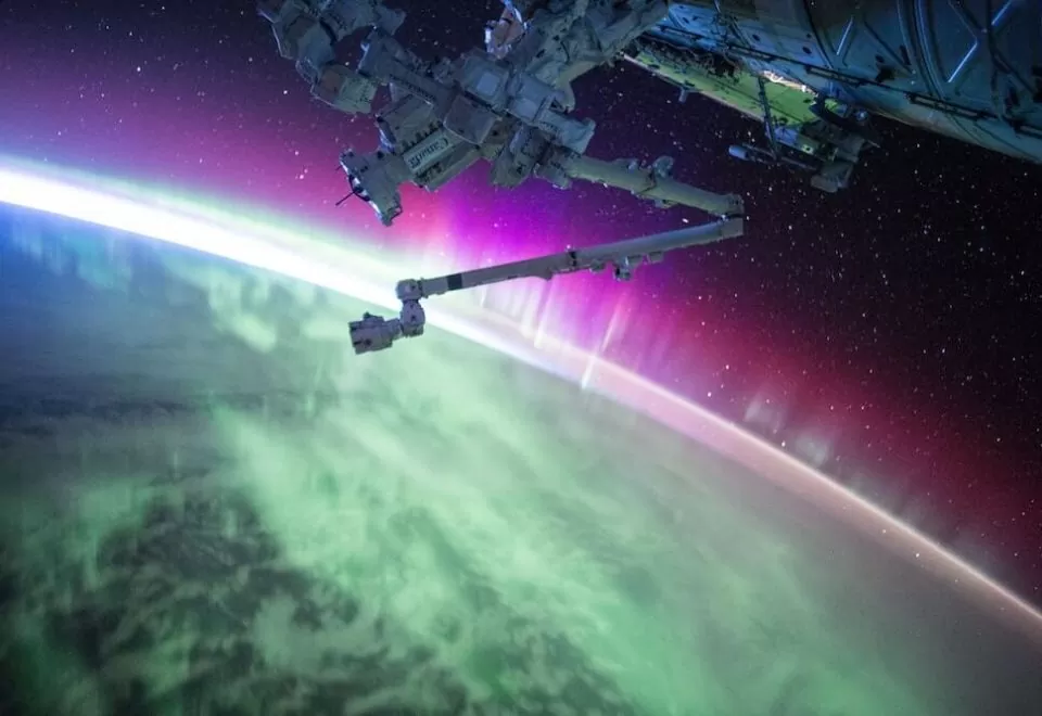 View of earth from space, featuring aurora lights.