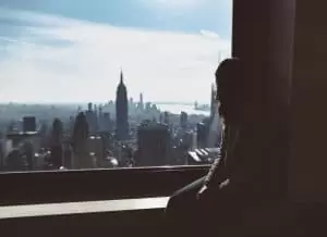 Woman in window viewing New York