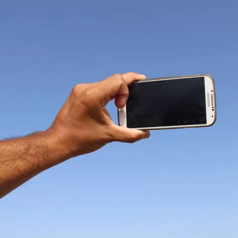 A smartphone in position to take a selfie.