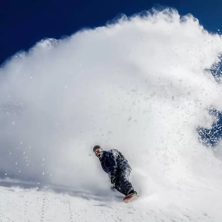Snowboarder creates a snow wave