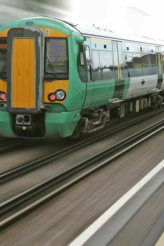 An image of a train travelling at speed. The train is in focus whilst the station background is blurred articulating the speed of the train. The time-lapse of trains, railroads and stations.
