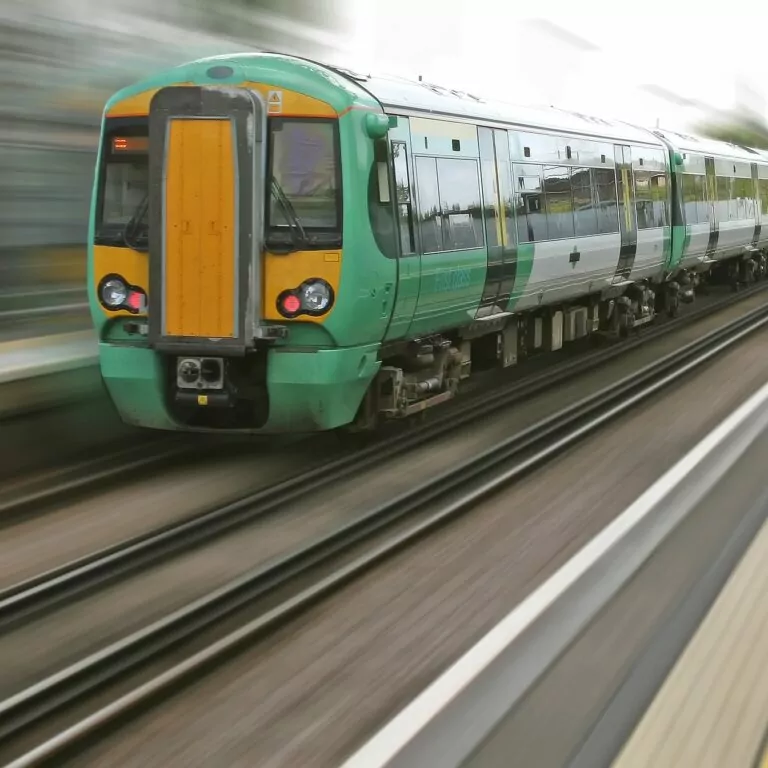 An image of a train travelling at speed. The train is in focus whilst the station background is blurred articulating the speed of the train. The time-lapse of trains, railroads and stations.