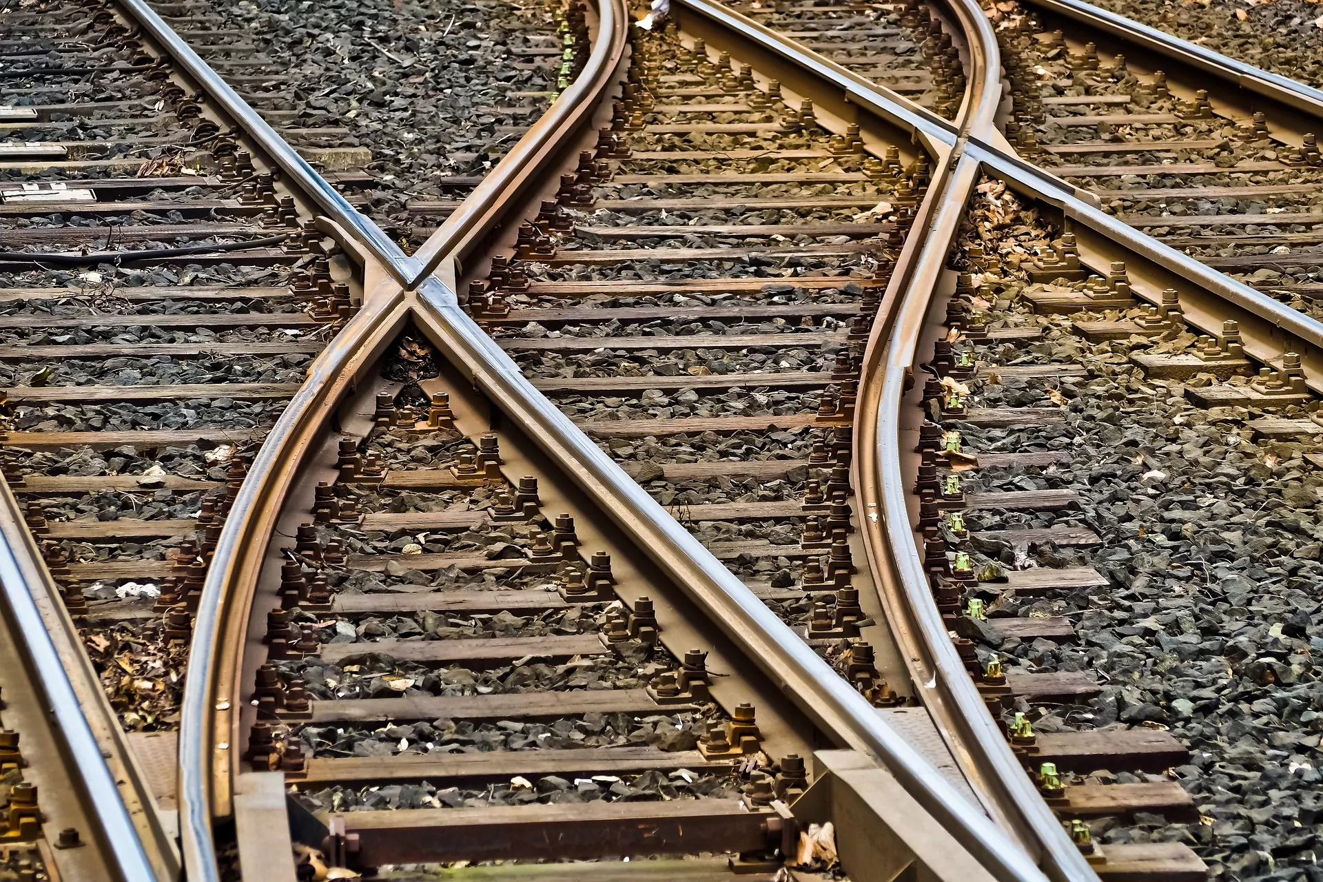 Image showing a close-up shot of a level junction. A range of railway tracks cross providing new track connections. The time-lapse of trains, railroads and stations.