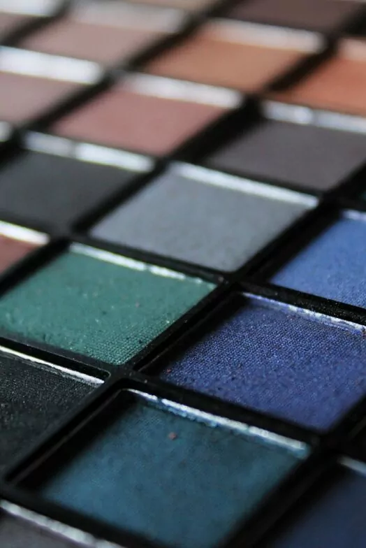 An image of an eyeshadow palette showing an array of different colours. Time-lapse of costume and make-up transformations.