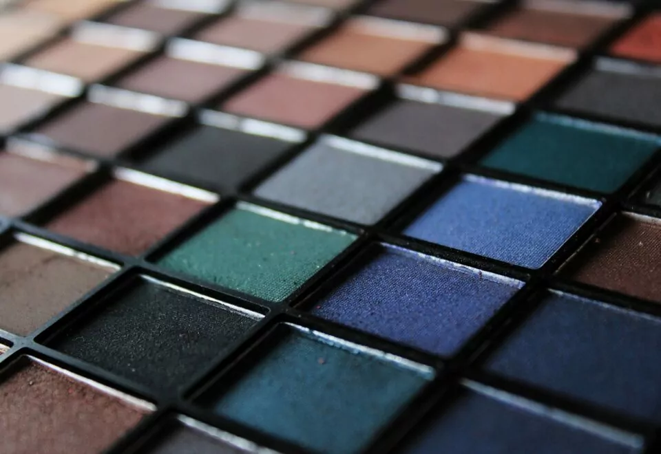 An image of an eyeshadow palette showing an array of different colours. Time-lapse of costume and make-up transformations.