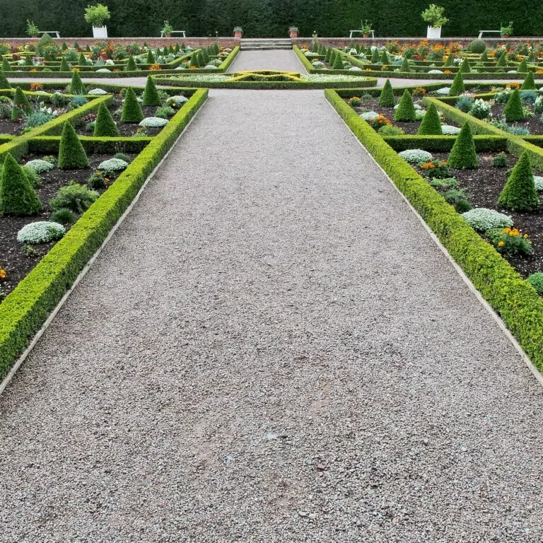 An image of symmetrical borders, artfully designed within a country Manor House's formal gardens. The Time-Lapse of Landscape Design.