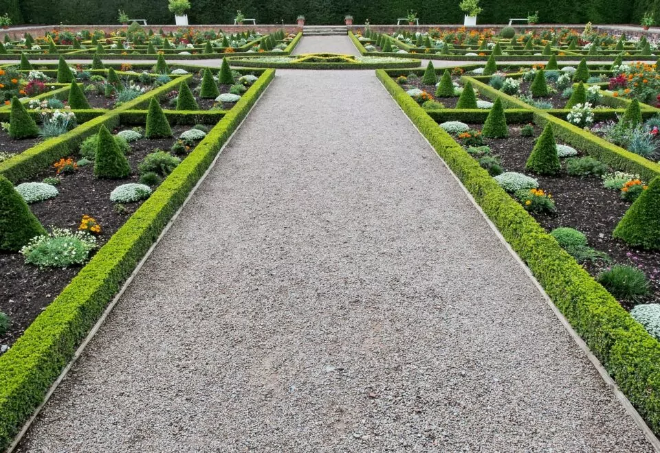 An image of symmetrical borders, artfully designed within a country Manor House's formal gardens. The Time-Lapse of Landscape Design.